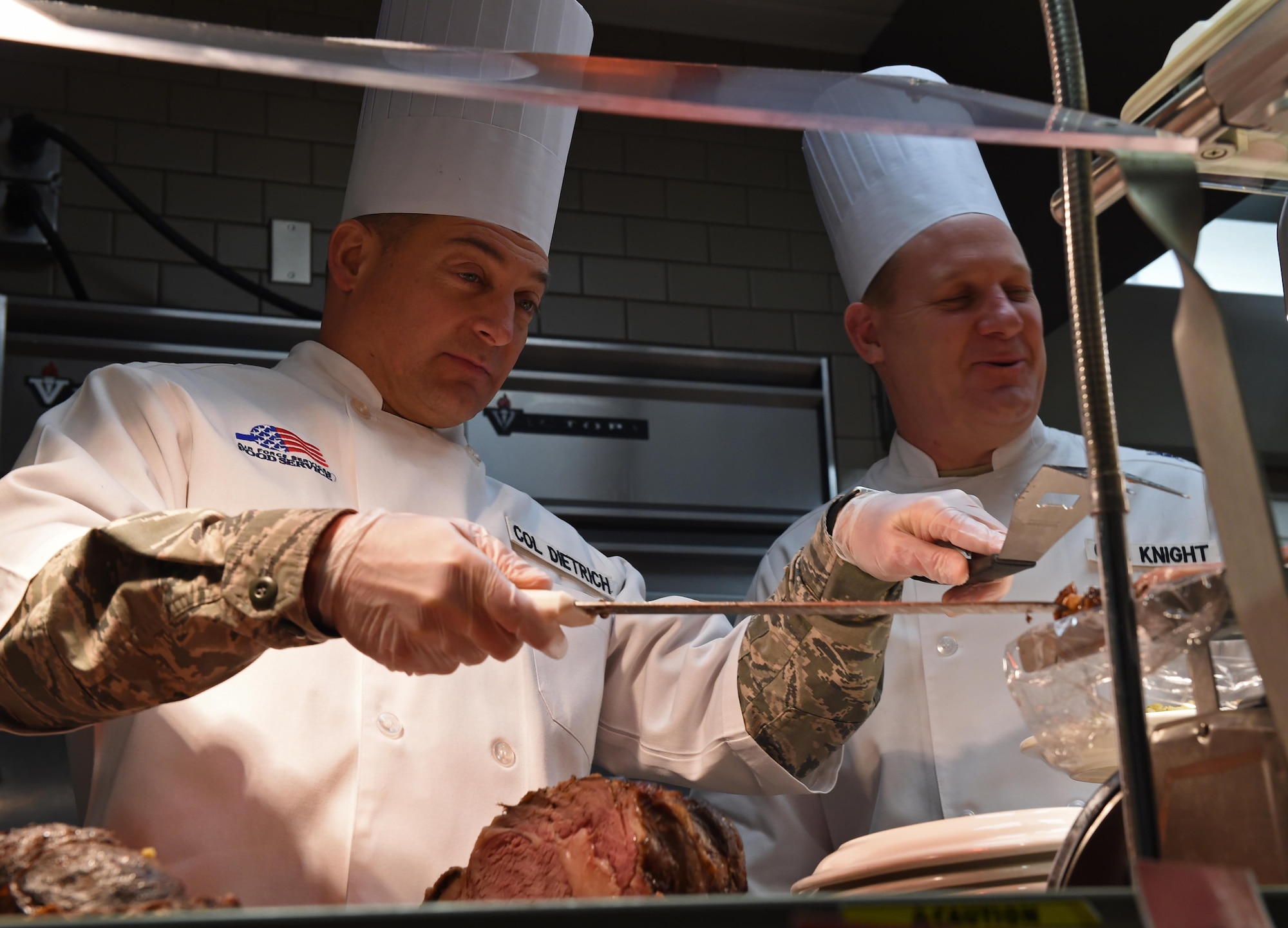 Col. George T.M. Dietrich III, 673d Air Base Wing and Joint Base Elmendorf-Richardson commander, serves up a slice of roast beef at the Iditarod Dining Facility at Joint Base Elmendorf-Richardson, Alaska, Dec. 25, 2016. JBER leadership served the community in an effort to show their appreciation and to wish everyone a Merry Christmas. 