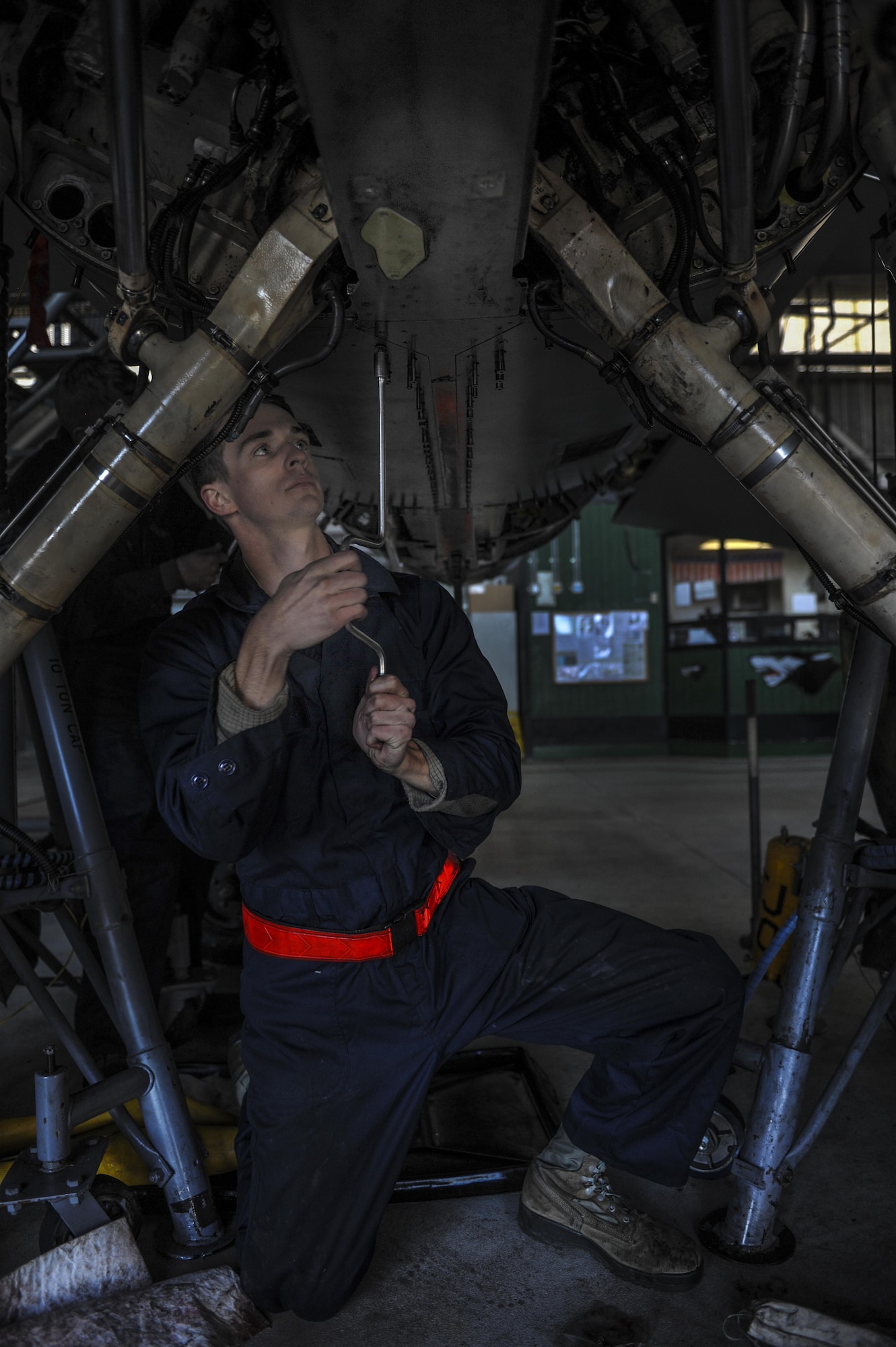 Airman 1st Class Alec Eckert, 8th Maintenance Squadron inspection section team member, screws panels into an F-16 Fighting Falcon at Kunsan Air Base, Republic of Korea, Dec. 6, 2016. Phase inspections are performed on aircraft every 400 flight hours and involve procedural maintenance actions that require robust attention to detail. (U.S. Air Force photo by Senior Airman Colville McFee/Released)