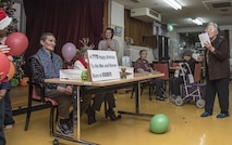 Akira, left, a Japanese elder, receives a birthday celebration from Miyako Fukuda, right, a Harunaoka Old Age Home event organizer and caretaker, at Misawa City, Japan, Dec. 22, 2016. Akira, who turned 72-years-old, celebrated his birthday along with others in the month of December. (U.S. Air Force photo by Airman 1st Class Sadie Colbert)