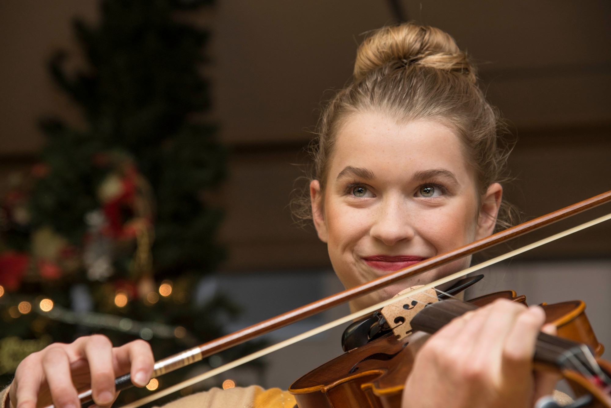 Leah Skaggs, daughter of Tech. Sgt. Erik Skaggs, the 35th Medical Group executive officer, plays the violin for Japanese elders at Harunaoka Old Age Home, Misawa City, Japan, Dec. 22, 2016. During their visit, Airmen and their families sang Christmas songs, gave gifts and played with the members. The Chapel and their groups visit the facility bi-monthly. (U.S. Air Force photo by Airman 1st Class Sadie Colbert)