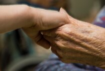 James Joiner III, left, son of Master Sgt. James Joiner, a 35th Civil Engineer Squadron explosives ordnance disposal technician, holds hand of Tanae, right, a Japanese elder at Harunaoka Old Age Home, Misawa City, Japan, Dec. 22, 2016. Many children walked around to meet members and talk with them. In 1984, the facility workers started to reach out to Misawa’s chapel to hold organized events every other month. (U.S. Air Force photo by Airman 1st Class Sadie Colbert)
