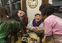 Rachel Skaggs, left, wife of Tech. Sgt. Erik Skaggs, the 35th Medical Group executive officer, shakes hands with Hiromu Ijiri, center, a Japanese elder, and Eiko Koiwa, a caretaker, at Harunaoka Old Age Home, Misawa City, Japan, Dec. 22, 2016. Misawa Air Base’s Chapel and its groups visit the facility bi-monthly to spend time with them, ensuring the members are not lonely. The facility provides help for elderly Japanese nationals who have no one to care for them. (U.S. Air Force photo by Airman 1st Class Sadie Colbert)