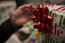 A member of the Shichinohe Orphanage, grabs a present during an event at Shichinohe, Japan, Dec. 23, 2016. U.S. Air Force Senior Airman Lowell Travis, the 35th Civil Engineer Squadron heavy planner, planned the event two weeks before Christmas to surprise the children at the facility. (U.S. Air Force photo by Airman 1st Class Sadie Colbert)