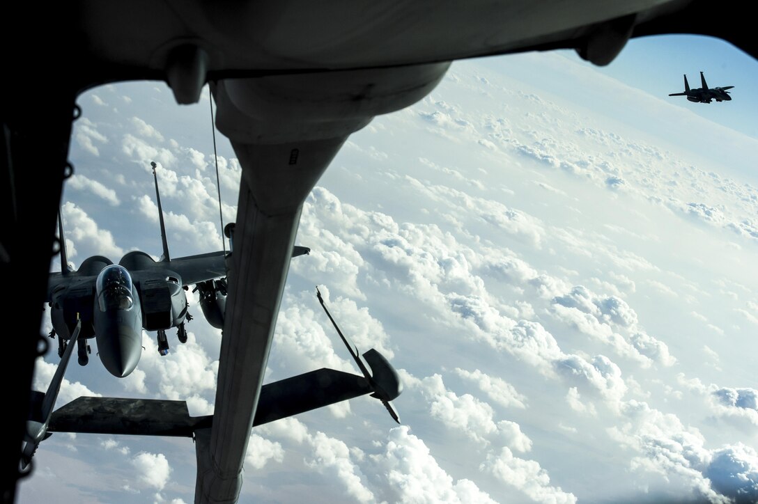 Two F-15E Strike Eagles prepare to receive fuel from a KC-10 Extender over Iraq, Dec. 25, 2016. F-15s are providing precision guided close air support during Combined Joint Task Force-Operation Inherent Resolve, a multinational effort to weaken and destroy Islamic State in Iraq and the Levant, operations in the Middle East region and around the world. (U.S. Air Force photo/Senior Airman Tyler Woodward)