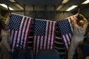 380th Air Expeditionary Wing KC-10 Extender crew members secure U.S. flags before flying a sortie in support of Combined Joint Task Force-Operation Inherent Resolve at an undisclosed location in Southwest Asia, Dec. 25, 2016. The flag flying program allows service members to share U.S. flags flown in current operations as gifts or memorabilia. (U.S. Air Force photo/Senior Airman Tyler Woodward)