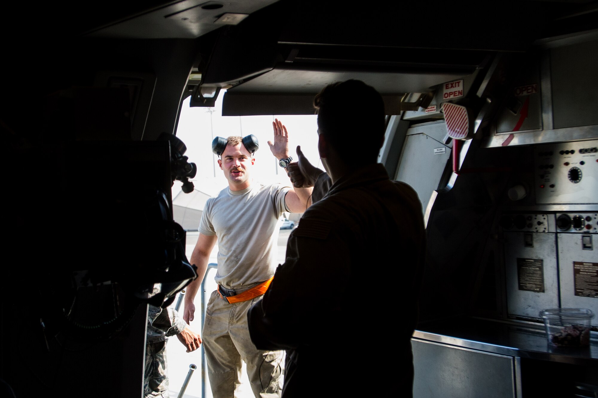 A 380th Air Expeditionary Wing KC-10 Extender crew chief exchanges farewells with a boom operator before flying a sortie in support of Combined Joint Task Force-Operation Inherent Resolve at an undisclosed location in Southwest Asia, Dec. 25, 2016. KC-10s have contributed to more than 1,200 precision guided strikes against Da’esh and Levant operations in Iraq. (U.S. Air Force photo/Senior Airman Tyler Woodward)