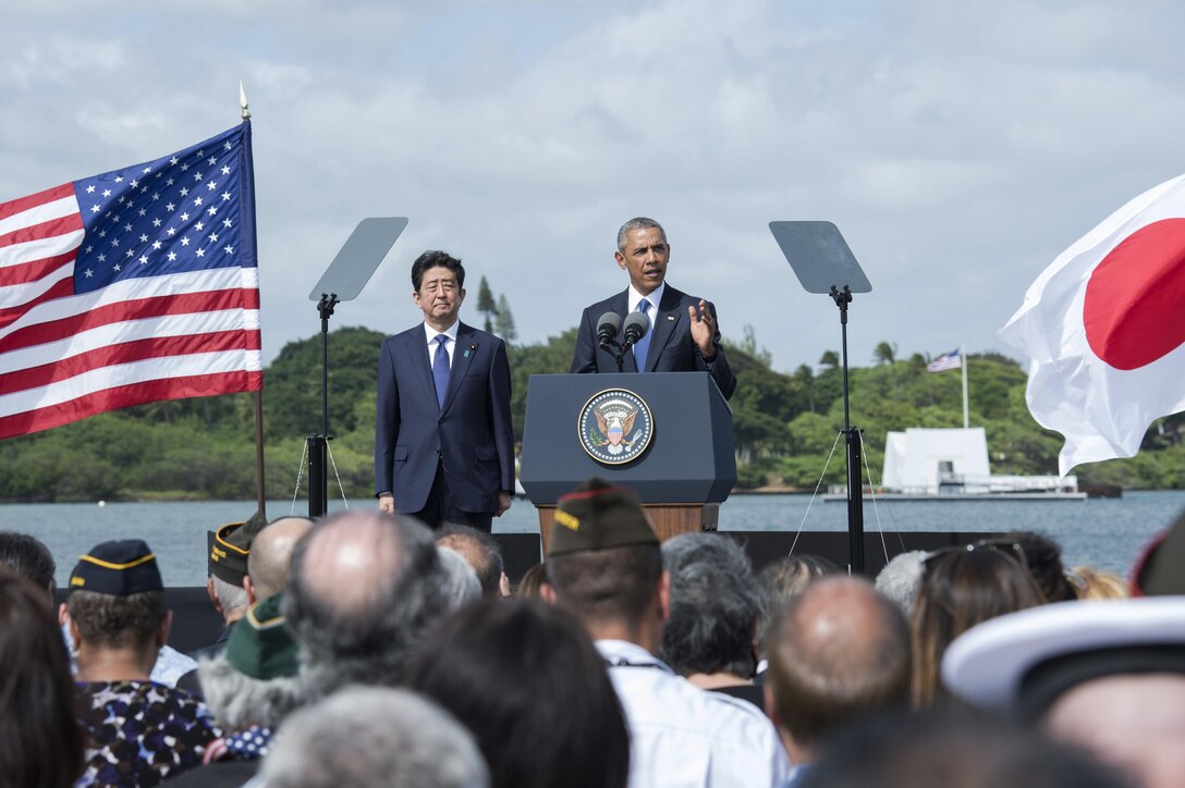 President Barack Obama speaks at Joint Base Pearl Harbor-Hickam, Hawaii, Dec. 27, 2016, while Japanese Prime Minister Shinzo Abe looks on. President Obama described the U.S.-Japan alliance as the cornerstone of peace and stability in the Asia-Pacific and a force for progress around the globe. Navy photo by Petty Officer 1st Class Jay Chu

