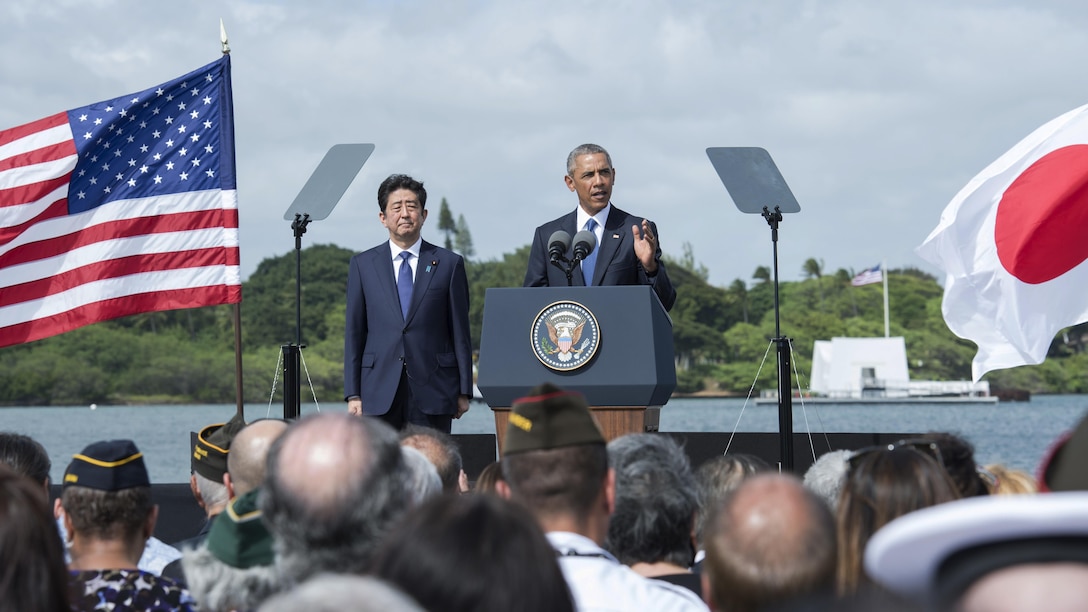 President Barack Obama speaks at Joint Base Pearl Harbor-Hickam, Hawaii, Dec. 27, 2016, while Japanese Prime Minister Shinzo Abe looks on. President Obama described the U.S.-Japan alliance as the cornerstone of peace and stability in the Asia-Pacific and a force for progress around the globe. Navy photo by Petty Officer 1st Class Jay Chu