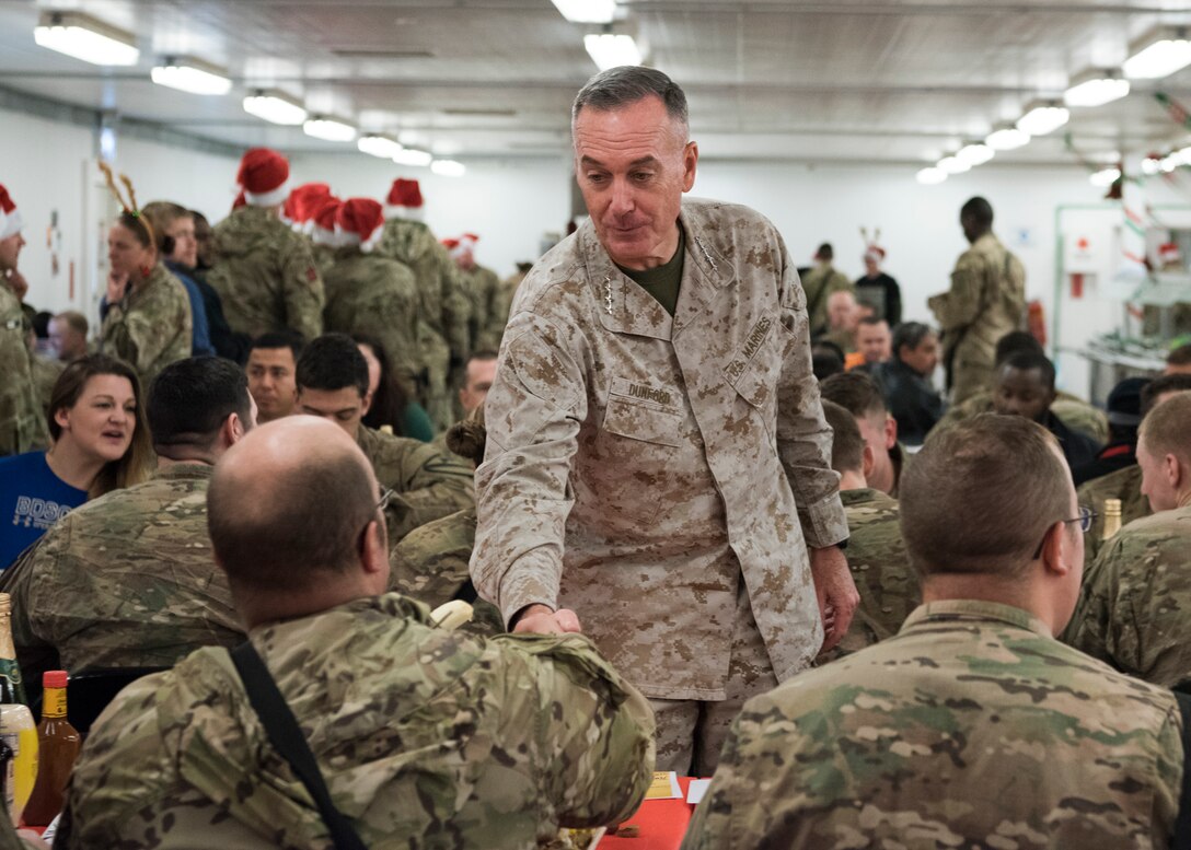 Marine Gen. Joseph F. Dunford, Jr., chairman of the Joint Chiefs of Staff, and Command Sgt. Maj. John W. Troxell, Senior Enlisted Advisor to the Chairman of the Joint Chiefs of Staff, meet with deployed service members at bases across Iraq, Dec. 25, 2016. Dunford, along with USO entertainers, visited service members who are deployed from home during the holidays at various locations across the globe. This year’s entertainers were Chef Robert Irvine, Wrestler Gail Kim, Musicians Kellie Pickler and Kyle Jacobs, and Roastmaster Jeff Ross. (DoD photo by Navy Petty Officer 2nd Class Dominique A. Pineiro/Released)