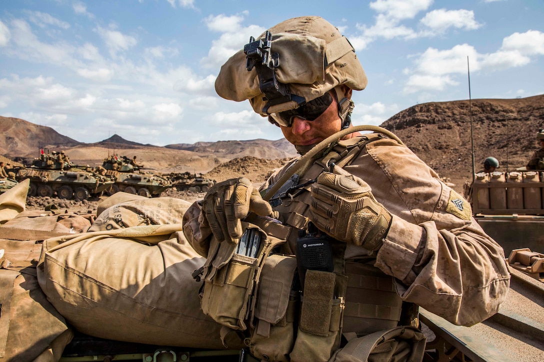 U.S. Marine Sgt. Ty West, a rifleman and scout chief with Light Armored Reconnaissance Company, Battalion Landing Team 1st Bn., 4th Marines, 11th Marine Expeditionary Unit, secures a radio after confirming vehicle positions before a hasty attack live-fire range during Exercise Alligator Dagger, Dec. 18, 2016. Each light armored vehicle crew includes a driver, gunner and four scouts who dismount to survey areas beyond mountains or hills, which aids the LAV team in staying out of vulnerable situations. The unilateral exercise provides an opportunity for the Makin Island Amphibious Ready Group and 11th MEU to train in amphibious operations within the U.S. 5th Fleet area of operations. The 11th MEU is currently supporting U.S. 5th Fleet’s mission to promote and maintain stability and security in the region. 