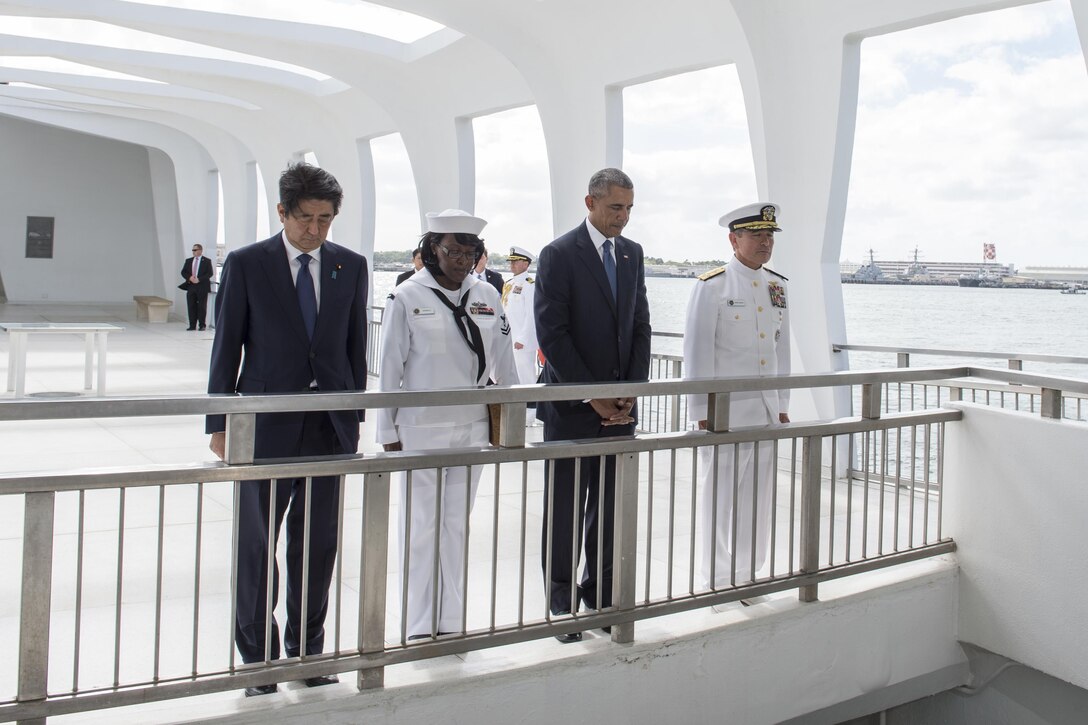 President Barack Obama and Japanese Prime Minister Shinzo Abe join Navy Adm. Harry B. Harris Jr., commander of U.S. Pacific Command, and Petty Officer 2nd Class Michelle Wrabley aboard the USS Arizona Memorial in Pearl Harbor, Hawaii, Dec. 27, 2016, to honor the service members killed during the Dec. 7, 1941, attack. Abe is the first Japanese prime minister to visit the USS Arizona Memorial. Navy photo by Petty Officer 1st Class Jay Chu