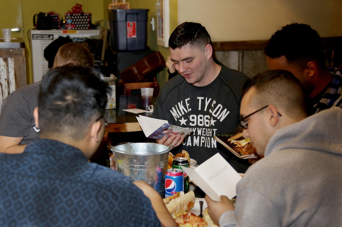 Service members read Christmas cards from elementary school students during the Single Marine Program’s annual Christmas dinner at the Roadhouse aboard Marine Corps Air Station Cherry Point, N.C., Dec. 25, 2016. The free homemade dinner was open to all single and unaccompanied Marines and Sailors. Activities went on all day at the Roadhouse to include holiday movies, a mega gingerbread house construction and white elephant gift exchange with gifts provided by the SMP. (Marine Corps photo by Cpl. Jason Jimenez/ Released)