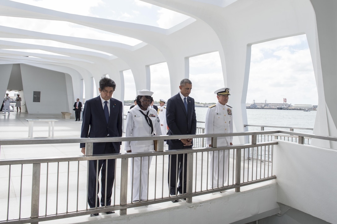 From left, Japanese Prime Minister Shinzo Abe, Navy Petty Officer 2nd Class Michelle Wrabley, President Barack Obama and U.S. Pacific Command Commander Navy Adm. Harry B. Harris Jr. pause at the USS Arizona Memorial to honor the service members killed during the Dec. 7, 1941, attacks at Pearl Harbor, Hawaii, Dec. 27, 2016. Abe was the first Japanese prime minister to visit the memorial. Navy photo by Petty Officer 1st Class Jay M. Chu