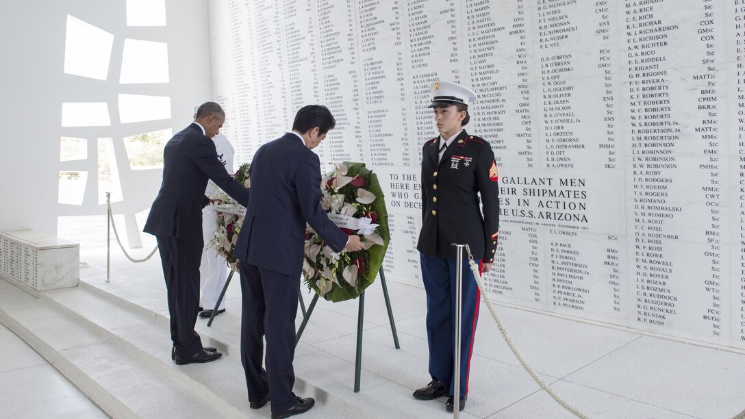 President Barack Obama and Japanese Prime Minister Shinzo Abe participate in a wreath-laying ceremony to honor service members who died in the Dec. 7, 1941 attack on Pearl Harbor during a ceremony aboard the USS Arizona Memorial in Hawaii.