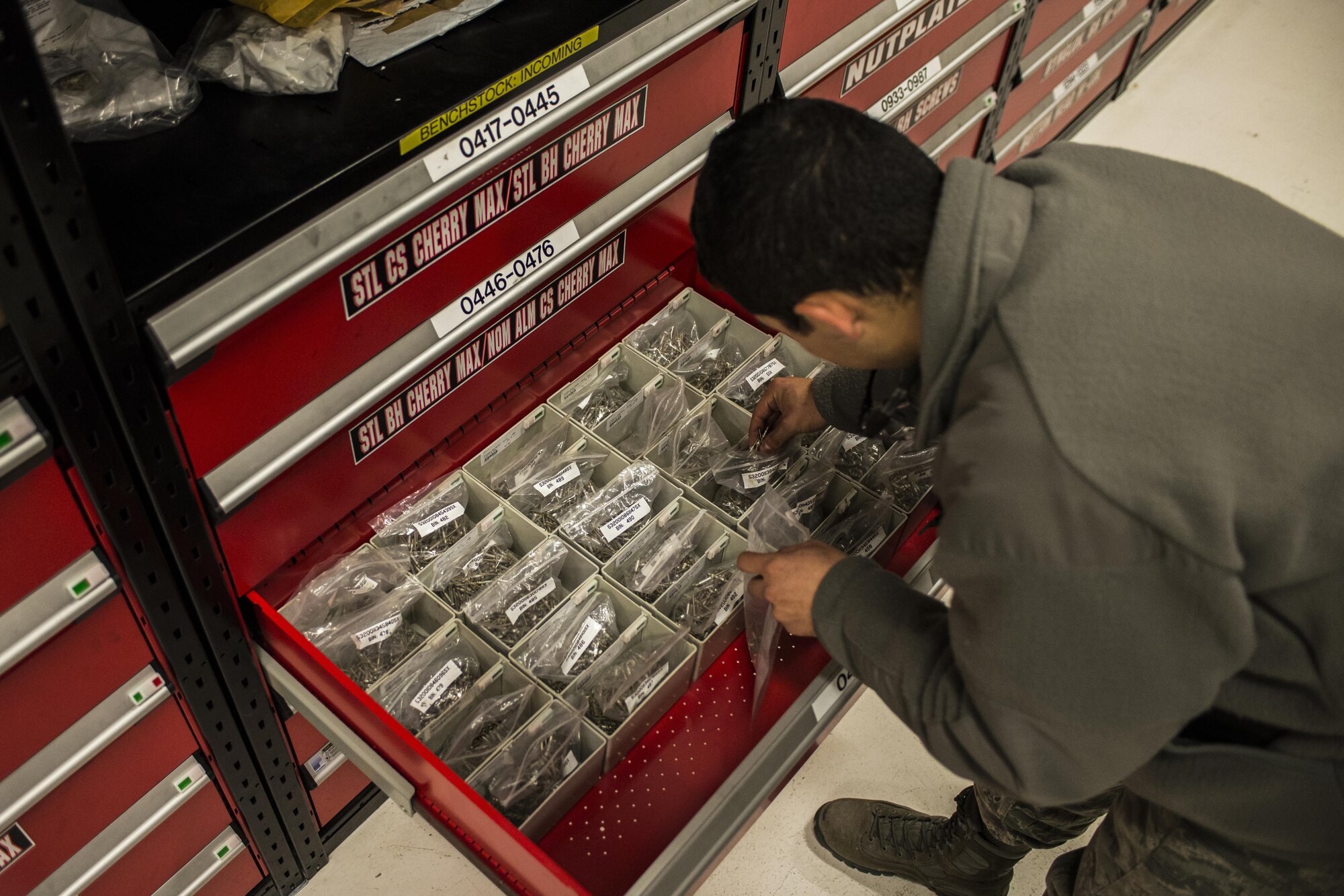 Airman 1st Class Caleb Jackson, 27th Special Operations Maintenance Squadron technician, finds the correct parts during restoring a MH-53 Pave Low helicopter Nov. 10, 2016, at Cannon Air Force Base, N.M. Technicians replaced old panels on the aircraft with new metal to increase the aircraft’s durability for its future role of being a static display. (U.S. Air Force photo by Senior Airman Luke Kitterman/Released)