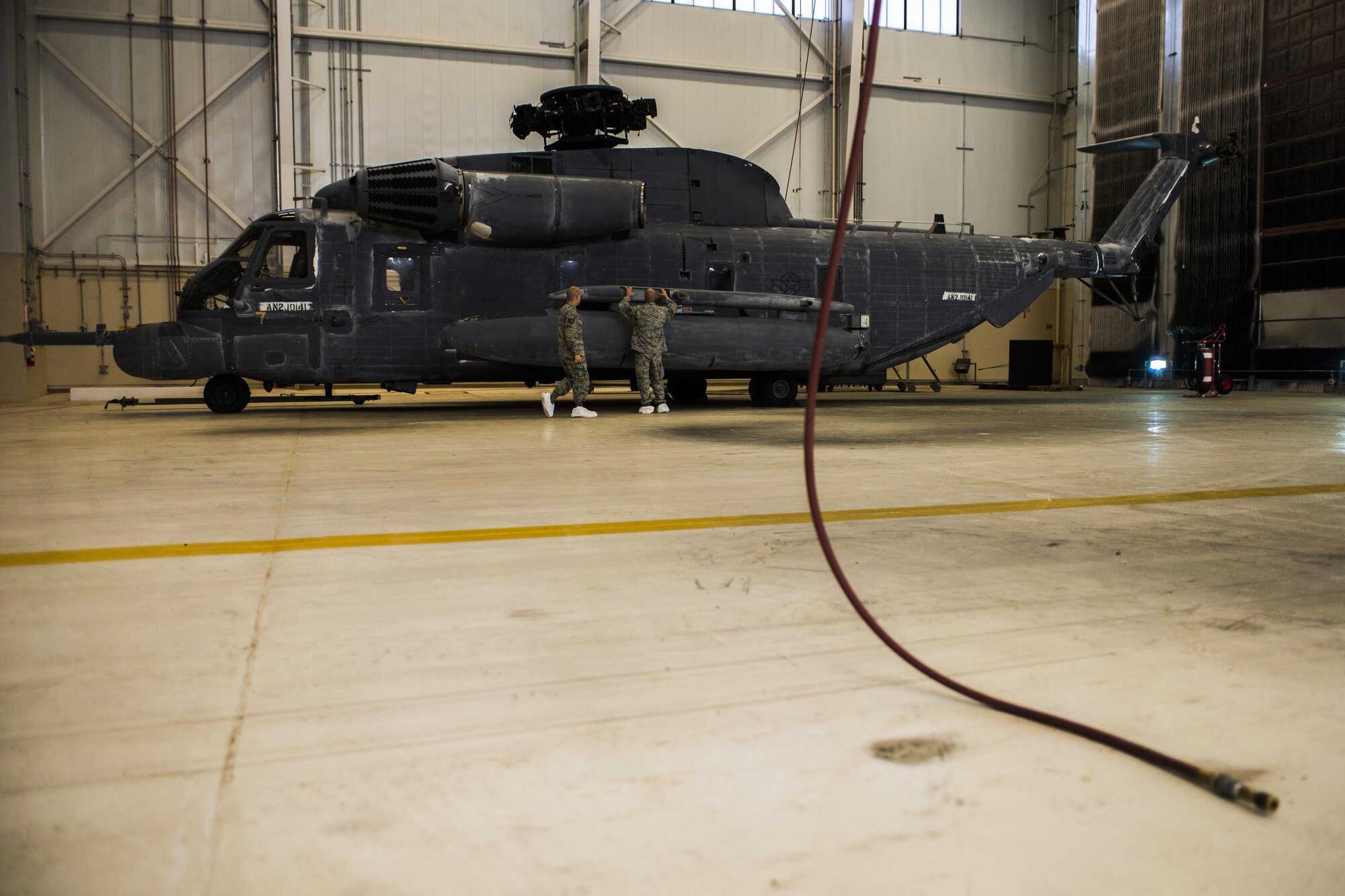Tech. Sgt. David Desporte, 27th Special Operations Maintenance Squadron aircraft structural maintenance section chief, left, and Tech. Sgt. George Mayo, 27th SOMXS corrosion control NCO in charge, perform an initial assessment of a MH-53 Pave Low helicopter Oct. 31, 2016, at Cannon Air Force Base, N.M. The Pave Low was a multi-month restoration project the aircraft structural maintenance team worked on for a static display at Cannon AFB’s front gate. (U.S. Air Force photo by Senior Airman Luke Kitterman/Released)