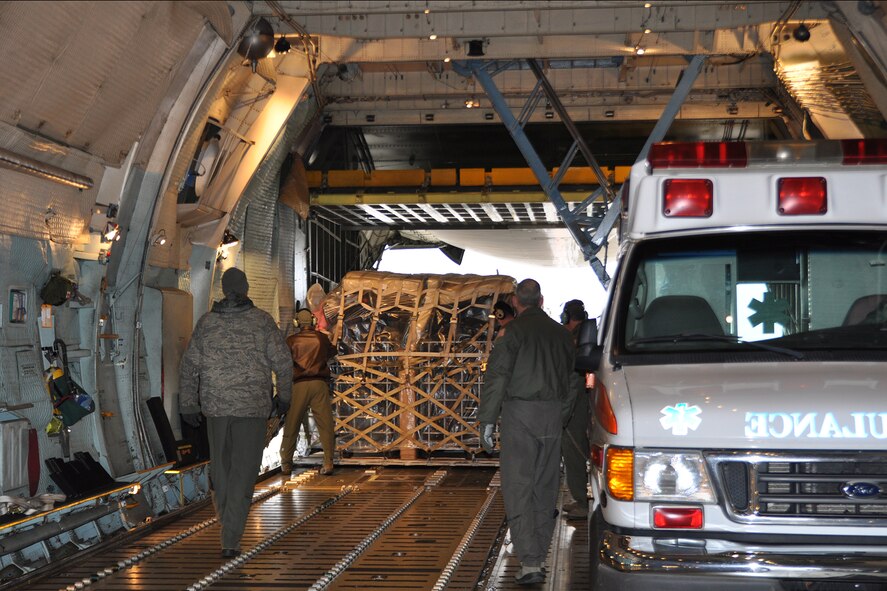 Loadmasters from Youngstown Air Reserve Station, Ohio, and Westover Air Reserve Base, Massachusetts, help load cargo into a Westover C-5 Galaxy cargo aircraft for a Denton cargo mission to Guatemala. The Denton program, overseen by the U.S. State Department, allows non-governmental organizations, such as the Austintown, Ohio-based Mission of Love Foundation, to use space available on military airlift aircraft to provide humanitarian aid to those in need worldwide. (U.S. Air Force photo/Maj. Polly Orcutt)