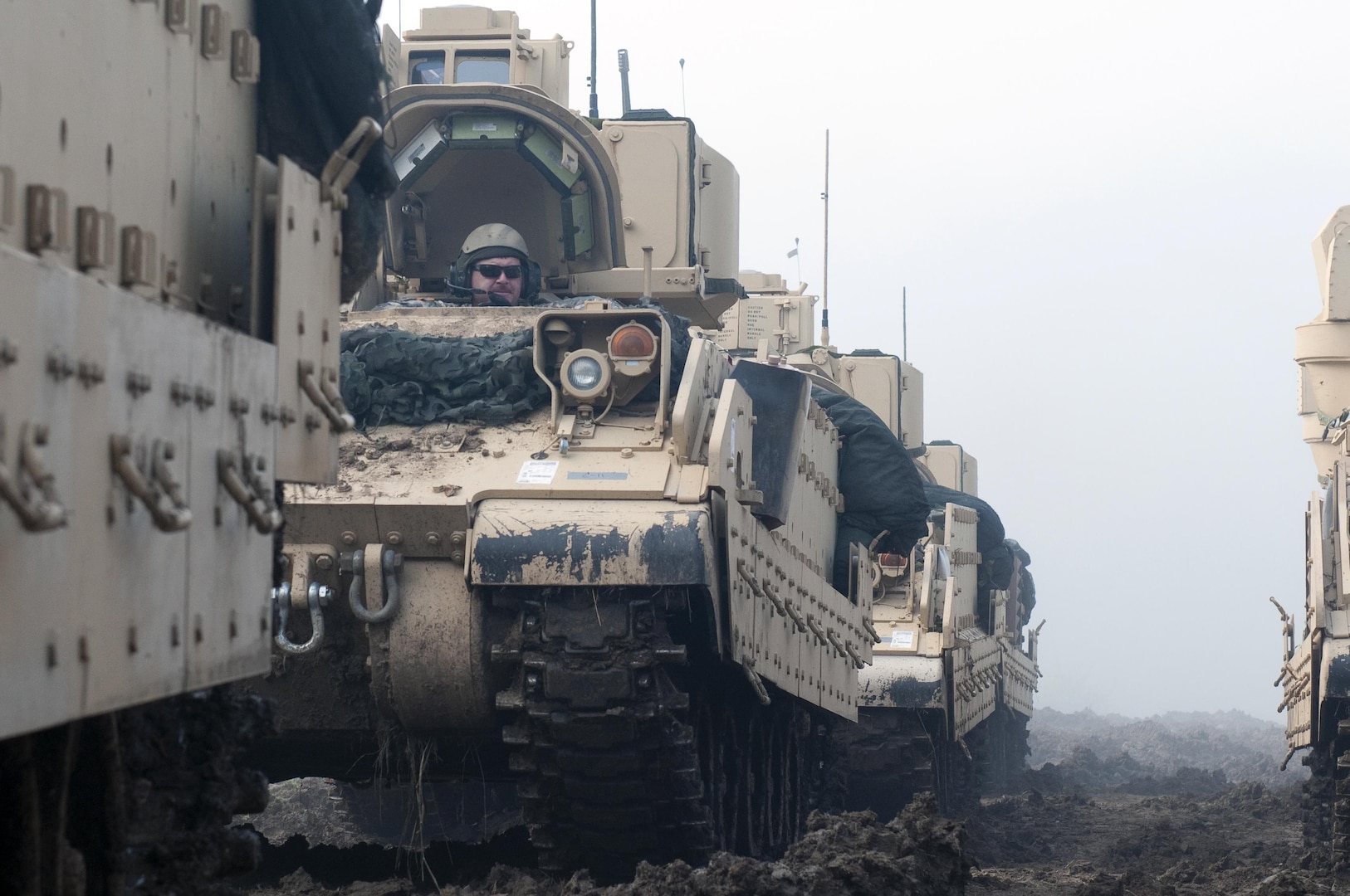 Soldiers with the Idaho Army National Guard's Troop A, 2nd Squadron, 116th Cavalry Regiment - many of them combat veterans - move their M2 Bradley Cavalry Fighting Vehicles into attack position during a training exercise in July. A recently signed law gives official veteran status to Soldiers and Airmen in the Guard who serve at least 20 years. Under previous law, Guard members were only considered veterans if they served 180 days or more in a federal status outside of training.  