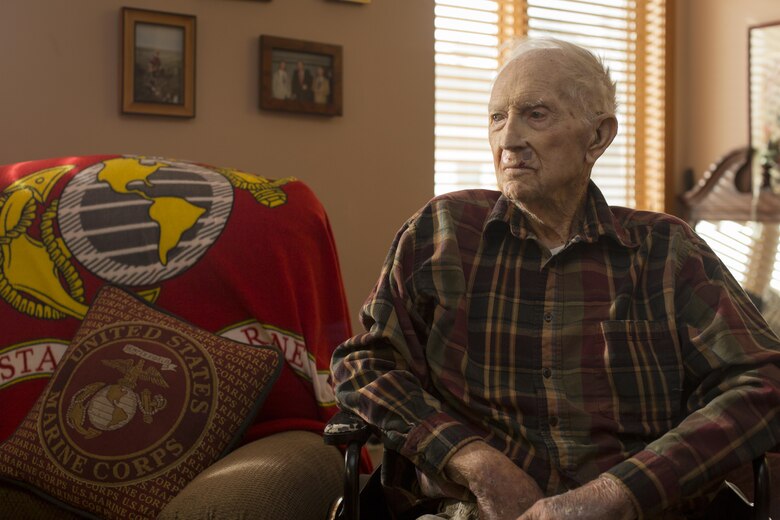 Retired 1st Lt. John J. O’Leary, a Marine veteran of World War II, looks at pictures on his dresser at the Evergreen Community of Johnson County, Olathe, Kan., Dec. 21, 2016. O’Leary fought on Guam and witnessed the bombardment of Iwo Jima as a member of 3rd Joint Assault Signal Company. He celebrated his 100th birthday on Dec. 23. (U.S. Marine Corps photo by Sgt. Ian Leones)