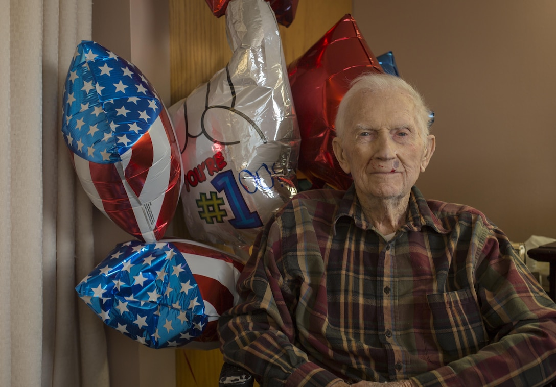 Retired 1st Lt. John J. O’Leary sits in front of birthday balloons at the Evergreen Community of Johnson County, Olathe, Kan., Dec. 21, 2016. O’Leary fought on Guam and witnessed the bombardment of Iwo Jima as a member of 3rd Joint Assault Signal Company. He celebrated his 100th birthday on Dec. 23. (U.S. Marine Corps photo by Sgt. Ian Leones)