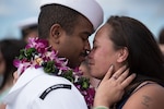 161223-N-KC128-0316 JOINT BASE PEARL HARBOR-HICKAM, Hawaii (December 23, 2016) A Sailor greets his loved one pierside at Joint Base Pearl Harbor-Hickam after the arrival of the Los Angeles-class attack submarine USS Buffalo (SSN 715) following the completion of her deployment to the Western Pacific Ocean. (U.S. Navy photo by Mass Communication Specialist 1st Class Daniel Hinton)