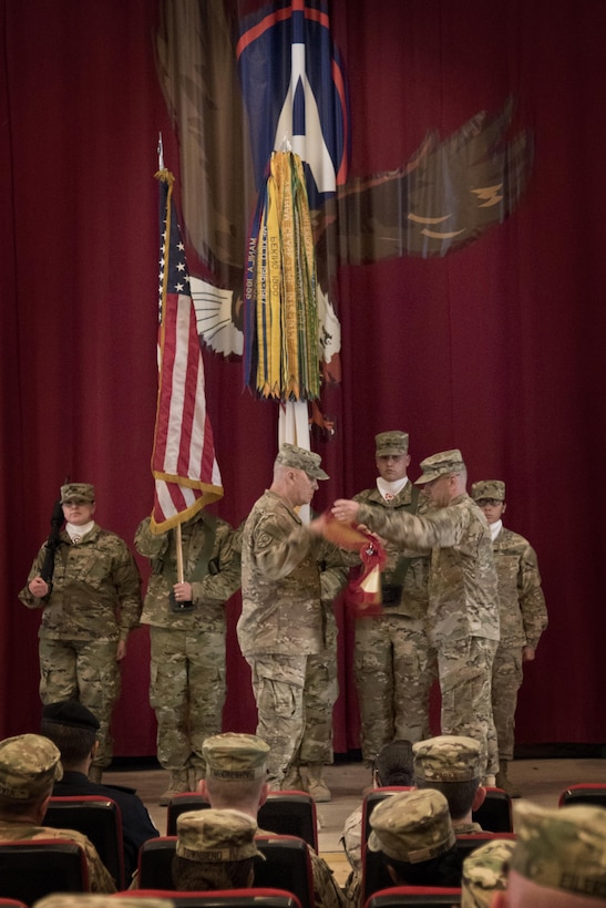 Brig. Gen. Bruce Hackett, the commanding general of the 451st Sustainment Command (Expeditionary), and Command Sgt. Maj. Dennis Thomas, the senior enlisted advisor of the 451st ESC, case their colors during the transfer of authority ceremony to the 316th ESC at Camp Arifjan, Kuwait, Dec. 23, 2016. (U.S. Army Photo by Staff Sgt. Dalton Smith)