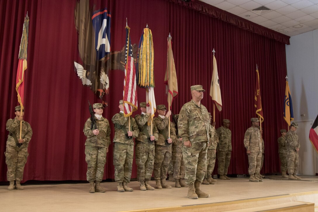 Col. Curtis Henry, the chief of staff of the 316th Sustainment Command (Expeditionary), calls a color guard to attention during a transfer of authority ceremony at Camp Arifjan, Kuwait, Dec. 23, 2016. (U.S. Army Photo by Staff Sgt. Dalton Smith)