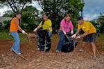 In this file photo, Yeoman 1st Class Erik Estrada, far right, assigned to the submarine tender USS Frank Cable (AS 40), helps local volunteers pack mulch into bags in the village of Dededo, Guam.  Frank Cable Sailors teamed up with volunteers from Island Girl Power, a local community service program for young girls, to clean and renovate a series of parks. Frank Cable, forward deployed to the island of Guam, conducts maintenance and support of submarines and surface vessels deployed to the U.S. 7th Fleet area of responsibility.