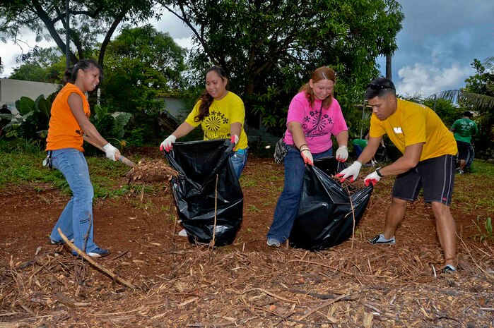 In this file photo, Yeoman 1st Class Erik Estrada, far right, assigned to the submarine tender USS Frank Cable (AS 40), helps local volunteers pack mulch into bags in the village of Dededo, Guam.  Frank Cable Sailors teamed up with volunteers from Island Girl Power, a local community service program for young girls, to clean and renovate a series of parks. Frank Cable, forward deployed to the island of Guam, conducts maintenance and support of submarines and surface vessels deployed to the U.S. 7th Fleet area of responsibility.