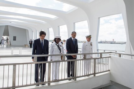 On Dec. 27, 2016, Japanese Prime Minister, Shinzo Abe,  Yeoman 2nd Class Michelle Wrabley, assigned to U.S. Pacific Fleet, President of the United States, Barack Obama, and U.S. Pacific Command Commander, Adm. Harry Harris pause to honor the service members killed during the Dec. 7, 1941 attacks on Pearl Harbor. Abe is the first Japanese prime minister to visit the USS Arizona Memorial. 