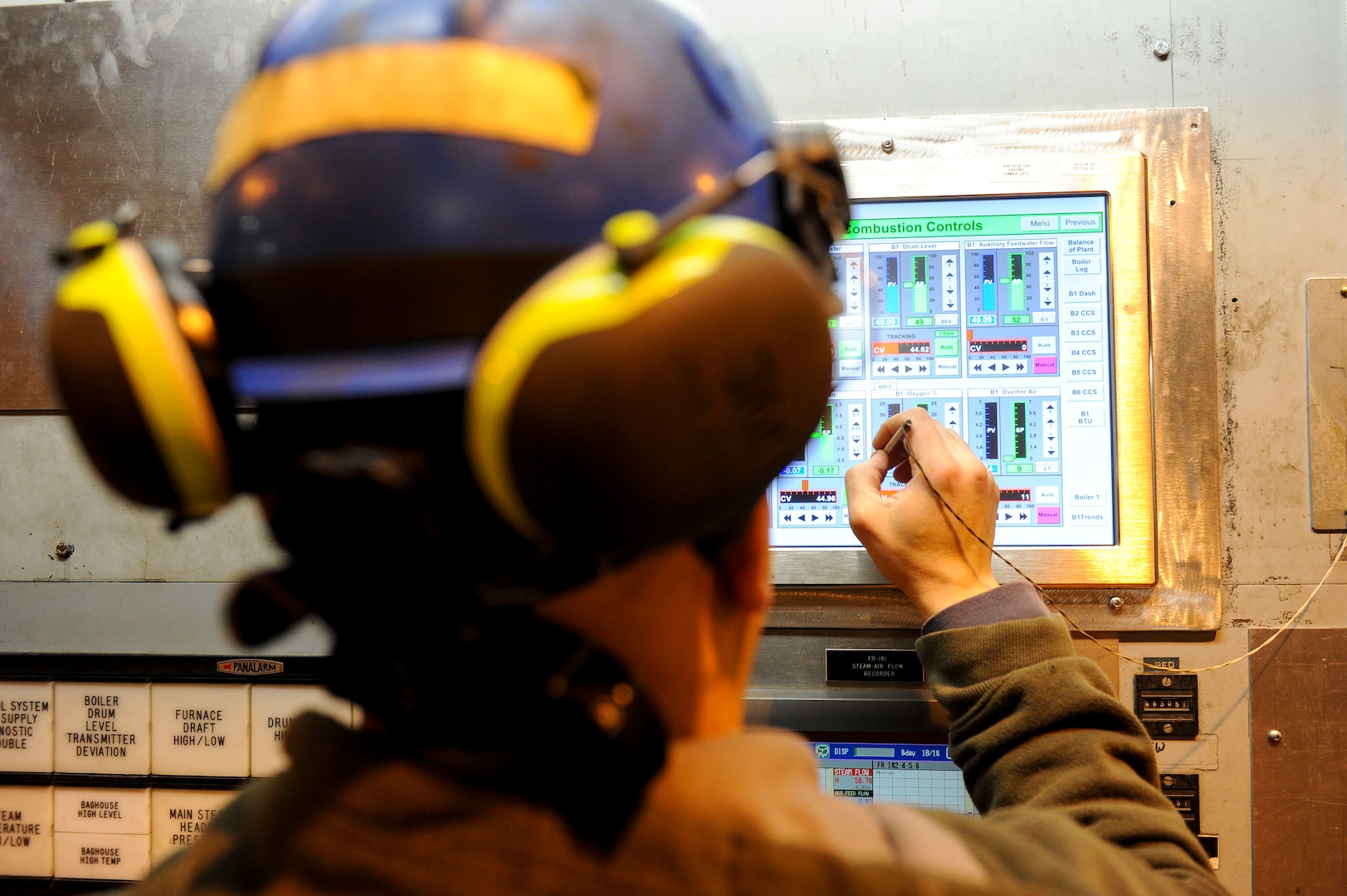 U.S. Air Force civilian Ian Martinez, a 354th Civil Engineer Squadron Central Heat and Power Plant (CHPP) assistant fireman, adjusts combustion controls Dec. 21, 2016, at Eielson Air Force Base Alaska. The CHPP was built in the early 1950s and much of the original equipment remains in use today. (U.S. Air Force photo by Airman Isaac Johnson)
