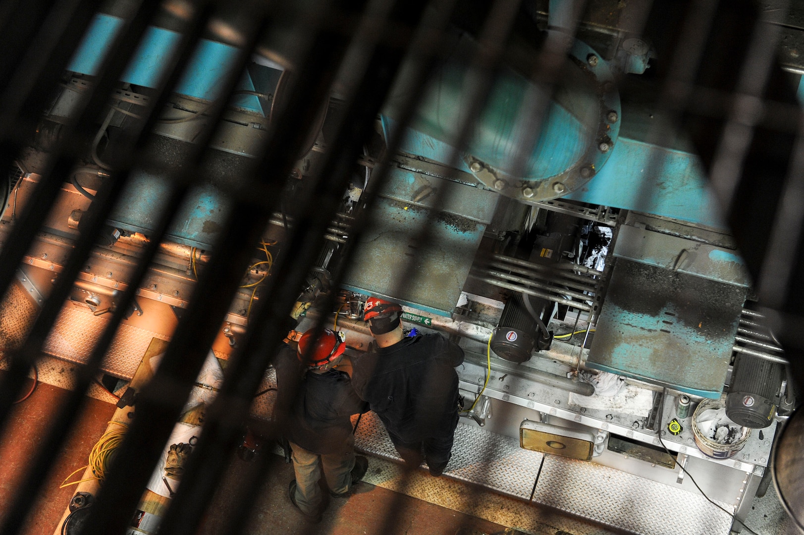 U.S. Air Force civilians, with the 354th Civil Engineer Squadron Central Heat and Power Plant work on boilers Dec. 21, 2016, at Eielson Air Force Base, Alaska. The CHPP uses about 180,000 tons of coal each year to keep the mission going here. (U.S. Air Force photo by Airman Isaac Johnson)