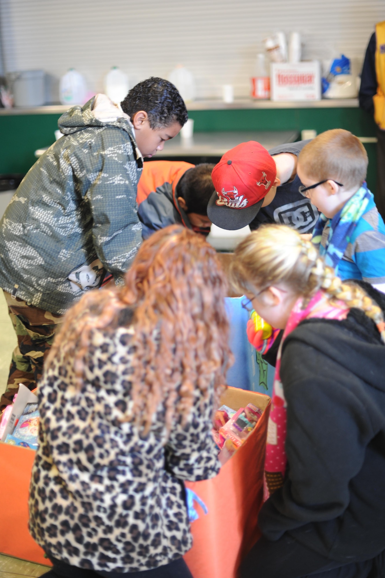 Children pick toys from a bin Dec. 20, 2016, at Cedar Lane Elementary School in Olivehurst, California. Hundreds of toys were donated to the Marysville Joint Unified School District’s homeless students and their families. (U.S. Air Force photo by Senior Airman Tara R. Abrahams)