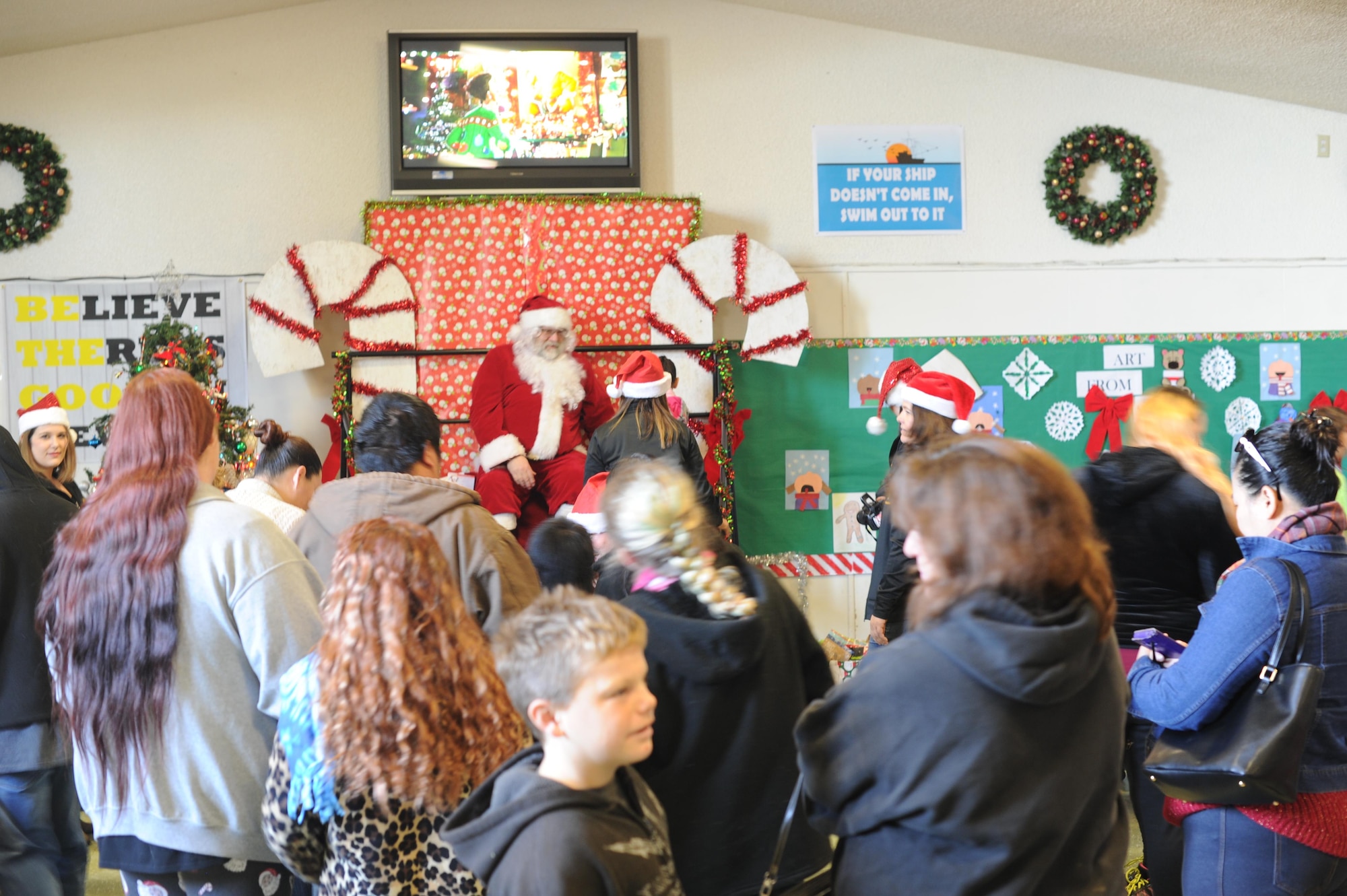 A crowd waits in line to meet Santa Claus Dec. 20, 2016, at Cedar Lane Elementary School in Olivehurst, California. Marysville Joint Unified School District’s homeless students and their families attended Breakfast with Santa and received hot breakfast and gifts donated by the community. (U.S. Air Force photo by Senior Airman Tara R. Abrahams)