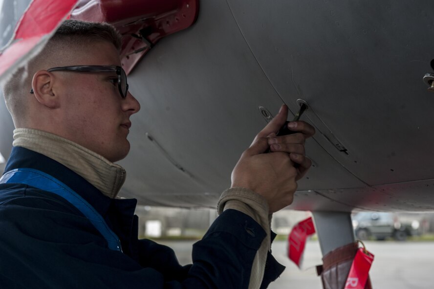 U.S. Air Force Airman 1st Class Brandon Murrell, 18th Equipment Maintenance Squadron crew chief, secures a panel on an F-15 Eagle Dec. 28, 2016, at Kadena Air Base, Japan. The F-15 Eagle is a vital component of maintaining peace and stability in the Pacific region. (U.S. Air Force photo by Senior Airman Lynette M. Rolen/Released)