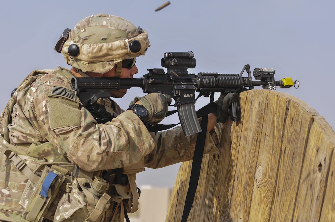 A Soldier with the 3rd Armored Brigade Combat Team, 1st Armored Division, engages an enemy sniper position during a squad overmatch training exercise at Camp Buehring, Kuwait, Dec. 15, 2016. The unique training opportunity incorporated a multi-platform teaching approach built on existing Army warrior skills training programs with detailed focus on improving situational awareness, psychological resilience, teamwork, tactical combat casualty care, and human performance enhancement. (U.S. Army photo by Sgt. Aaron Ellerman)
