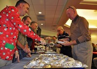 Retired Lt. Gen. James Sherrard, a former 919th Tactical Airlift Group member, moves along a holiday steak luncheon serving line staffed by volunteers from the 919th Special Operations Maintenance Group at Duke Field, Fla., Dec. 16.  Sherrard was one of 10 of the 919th Special Operations Wing's retired former leaders and members invited to tour the base and receive updates on the Air Force Reserve unit’s rapidly evolving mission sets.  (U.S. Air Force photo/Dan Neely)