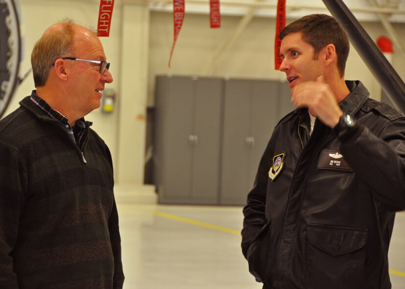 Maj. James Bosak, an 859th Special Operations Squadron pilot, discusses new developments within his non-standard aviation unit with retired Maj. Gen. Michael Wilson, a former 711th Special Operations commander, at Duke Field, Fla., Dec. 16.   Wilson was one of 10 of the wing’s retired former leaders and members invited to tour the base and receive updates on the Air Force Reserve unit’s rapidly evolving mission sets. (U.S. Air Force photo/Dan Neely)