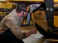 Airman 1st Class Brennan Walley, 5th Logistics Readiness Squadron vehicle maintenance technician, tightens a bolt on a grader vehicle at Minot Air Force Base, N.D., Dec. 14, 2016. The 5th LRS special purpose maintainers are trained to perform inspections, repairs and rebuild vehicle components and assemblies. (U.S. Air Force photo/Airman 1st Class Jonathan McElderry)