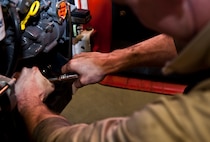 An Airman with the 5th Logistics Readiness Squadron special purpose shop tightens a bolt on a forklift at Minot Air Force Base, N.D., Dec. 14, 2016. Airmen in the 5th LRS special purpose shop perform maintenance on various types of equipment, from gasoline and diesel engines, to hydraulic and air systems. (U.S. Air Force photo/Airman 1st Class Jonathan McElderry)
