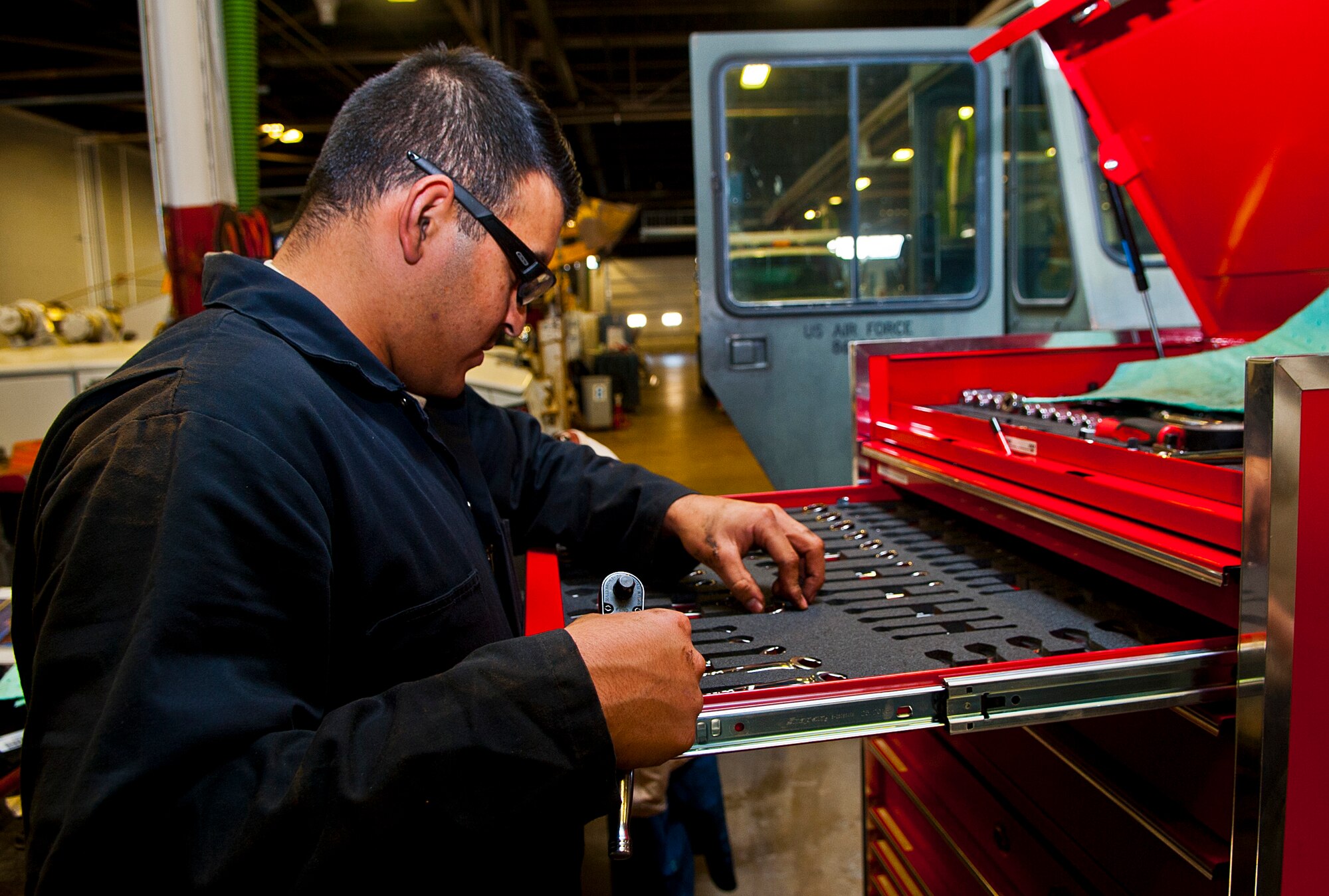 Airman 1st Class Rodrigo Salgado, 5th Logistics Readiness Squadron vehicle maintenance technician, looks for a socket tool at Minot Air Force Base, N.D., Dec. 14, 2016. Airmen in the 5th LRS special purpose shop are responsible for servicing all Minot AFB vehicles to ensure base operations continue running smoothly. (U.S. Air Force photo/Airman 1st Class Jonathan McElderry)