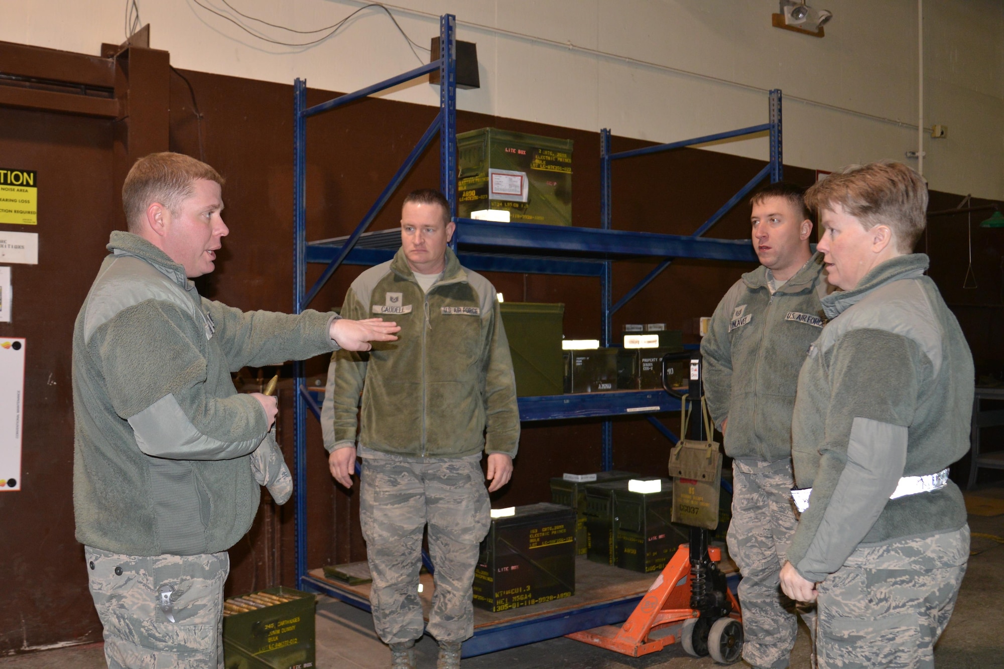 U.S. Air Force munitions specialists Senior Master Sgt. Keith Long, Technical Sgt.  David Caudell and Staff Sgt. Joe Dunlavey from the 477th Fighter Group showcase equipment and capabilities from the 3rd Munitions Flight November 6, 2016. Munitions Systems specialists are Airmen tasked with handling, storing, transporting, arming and disarming non-nuclear weapons systems. The Munitions Systems career field is commonly referred to as "ammo." (Photo by Maj. Carla Gleason, Released)