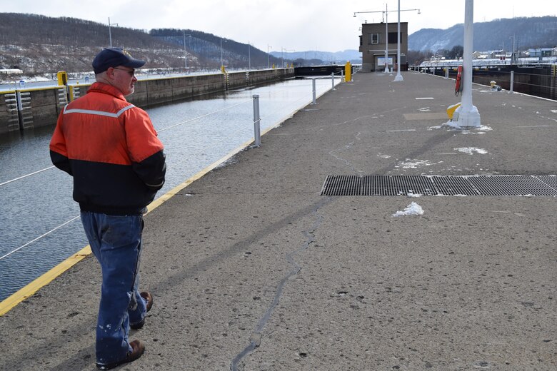 Lockmaster Willie Maynard at New Cumberland Locks and Dam walks along the middle wall toward the downstream end of the facility where crews are working to fix a hydraulic failure that closed the upper Ohio River to commercial traffic.