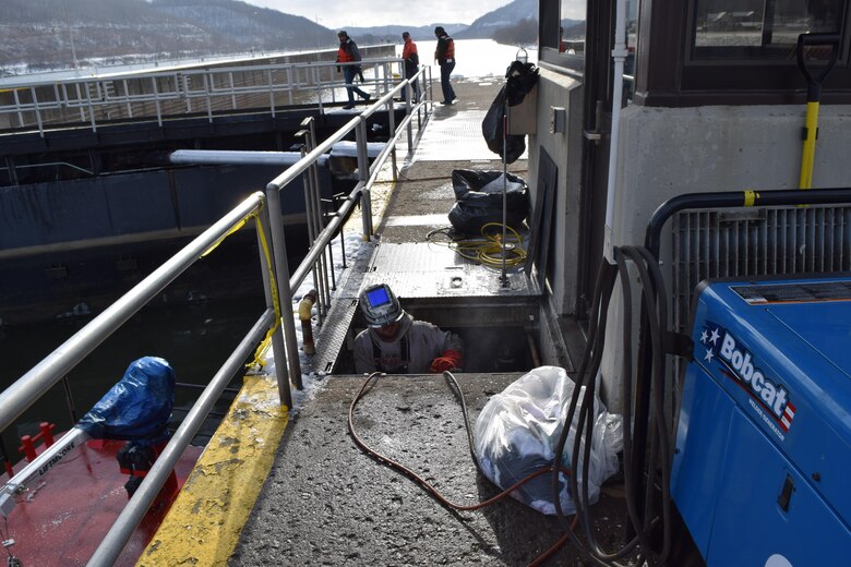 A welder emerges from a mechanical trench at New Cumberland Locks and Dam where he works to cap hydraulic lines that failed Dec. 12, closing the upper Ohio River to commercial vessels. 