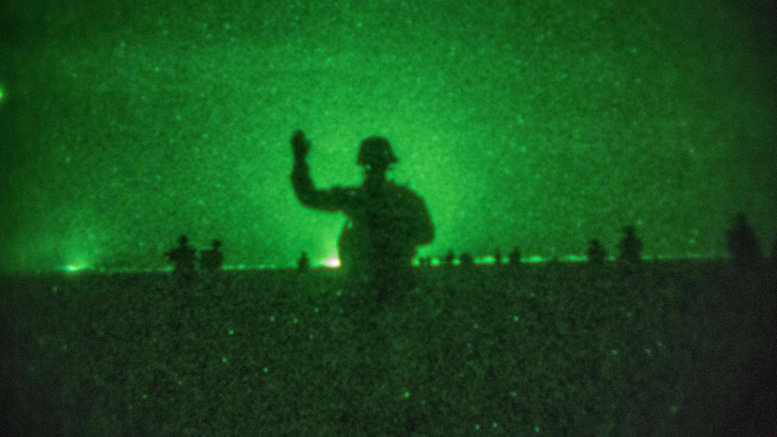 A U.S. Marine with Company C, Battalion Landing Team 1st Bn., 4th Marines, 11th Marine Expeditionary Unit, gives the signal to advance onto the objective area during a helo-borne raid as part of Exercise Alligator Dagger in Djibouti, Dec. 22, 2016. The raid involved Marines inserting onto an objective via MV-22 Ospreys and CH-53E Super Stallions, neutralizing simulated enemy threats onsite, and performing a thorough site exploitation of enemy intelligence before extracting all forces from the area, along with apprehended high-value individuals. The unilateral exercise provides an opportunity for the Makin Island Amphibious Ready Group and 11th MEU to train in amphibious operations within the U.S. 5th Fleet area of operations. The 11th MEU is currently supporting U.S. 5th Fleet’s mission to promote and maintain stability and security in the region.