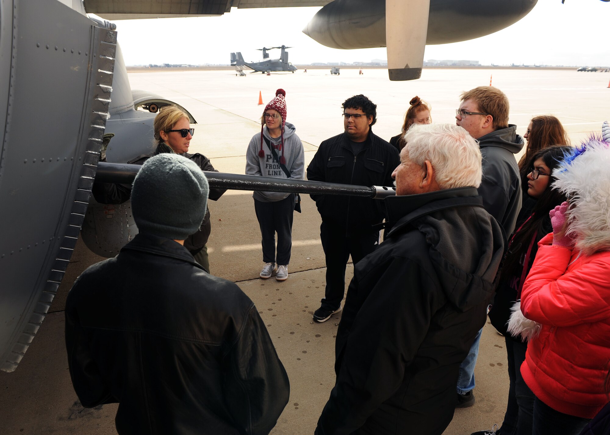 Capt. Katie Schuler, 16th Special Operations Squadron pilot, talks about AC-130W gunship capabilities during a tour for Portales High School Math Engineering and Science Achievement club members, Dec. 9, 2016, at Cannon Air Force Base, N.M. The tour, which consisted of an AC-130 technology brief and an in-depth look at a powered-on AC-130W, was designed to give students a practical look at real world math, engineering and science applications. (U.S. Air Force photo by Staff Sgt. Whitney Amstutz/Released)