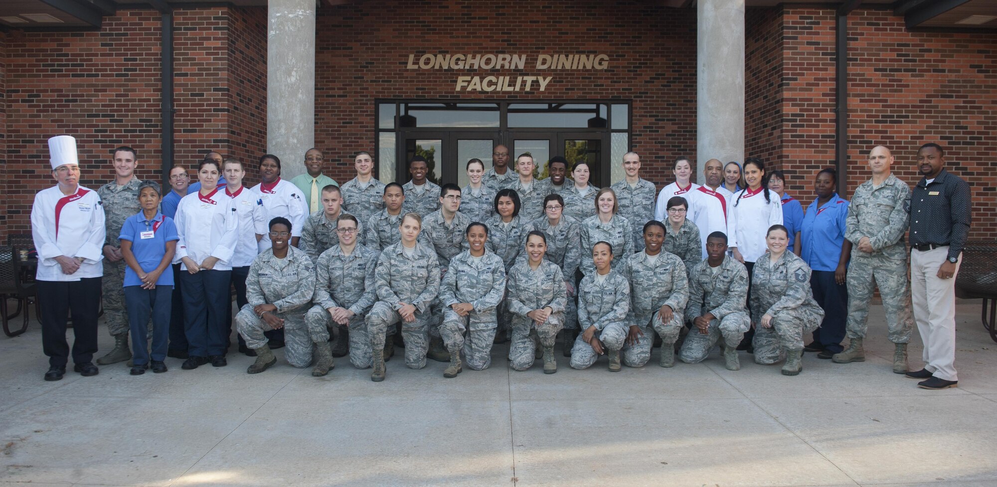 The Longhorn Dining Facility staff from the 7th Force Support Squadron pose for a group picture at Dyess Air Force Base, Texas, Nov. 1, 2016. The team is separated between the main Longhorn Dining Facility and The Lift Kitchen, a 24 hours a day, seven days a week flightline kiosk designed to accommodate Airmen with schedules that make it difficult to eat at the dining facility during its open hours. (U.S. Air Force Photo by Airman 1st Class Rebecca Van Syoc)
