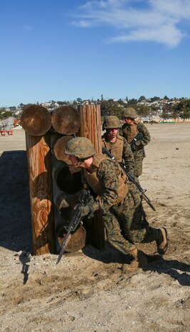 Recruits of Lima Company, 3rd Recruit Training Battalion, rush through an obstacle as a fireteam during the Bayonet Assault Course at Marine Corps Recruit Depot San Diego, Dec. 27. Recruits were instructed to move quickly as a fireteam throughout the course in order to simulate combat situations. Annually, more than 17,000 males recruited from the Western Recruiting Region are trained at MCRD San Diego. Lima Company is scheduled to graduate Jan. 20.