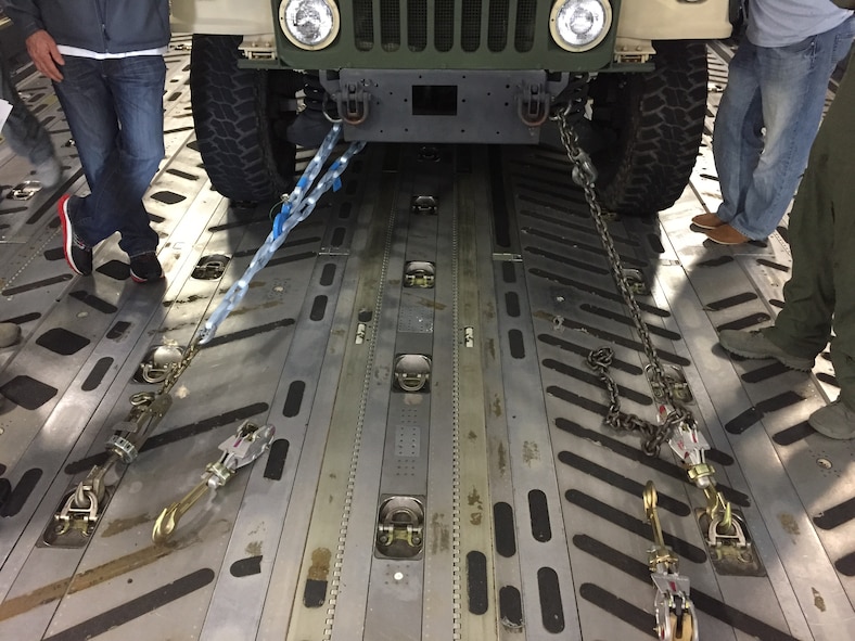 A Humvee is secured with the existing tie downs and new synthetic tie downs to conduct a side-by-side demonstration during an operational evaluation on Joint Base Charleston, S.C., Nov. 28, 2016. The new tie downs and winch cables will reduce weight by nearly 1,000 pounds on each C-17 Globemaster III, and save the Air Force approximately $4 million annually. (Courtesy photo)