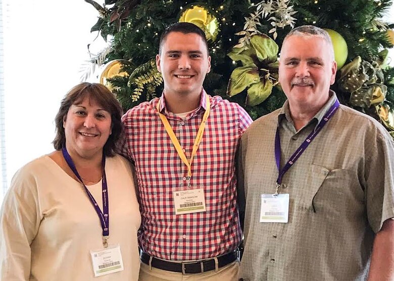 Staff Sgt. Dale N. Ransom (center) and parents Donna and Dale attend a Yellow Ribbon Program event in Orlando, Florida on December 17, 2016. The Air Force Reserve Yellow Ribbon Program is designed to assist reservists and National Guard members in maintaining resiliency as they transition between their military and civilian roles before, during and after deployment. (U.S. Air Force photo by Capt. Brian Haun)